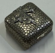 A Continental silver hinged box with snakeskin design.