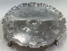 A large 18th Century silver salver with bright-cut decoration.