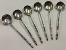 A set of six Russian silver spoons with chased decoration and spiralled handles.