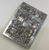 A large chased Indian silver card case with hinged lid.