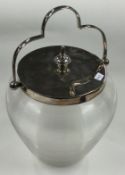 A large silver plated and glass swing handled biscuit barrel.