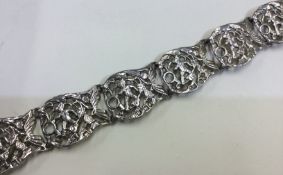 A large pierced silver belt chased with cherubs.