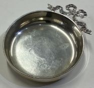 A Continental silver dish with swag handle.