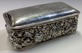 A chased silver jewellery box embossed with flowers.