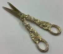 A pair of George III silver gilt grape scissors embossed with vines and figures.
