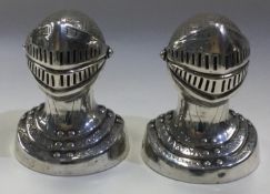 A fine pair of novelty silver peppers in the form of knight's helmets.