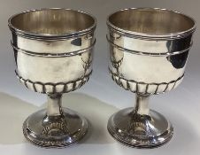 NEWCASTLE: A good pair of half fluted tapering silver beakers. By Ann Robertson.