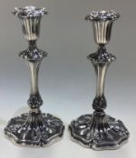 A good pair of Victorian silver dwarf candlesticks with scroll decoration.