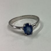 A small blue stone ring in white gold mount.