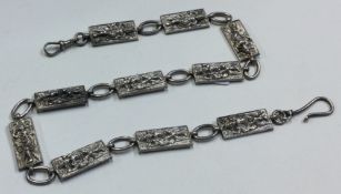 A Thai silver belt embossed with figures.