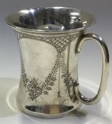 A Victorian silver christening mug with swag decoration.