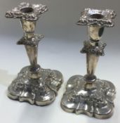A pair of chased silver candlesticks.