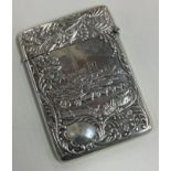 A heavy chased silver double-sided castle top card case depicting horses and carriage.