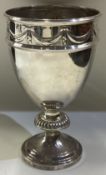 A large and heavy Victorian silver goblet with swag decoration.