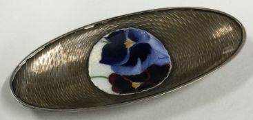 An engine turned silver and enamelled dish with floral decoration.