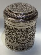 A heavy chased Indian silver tea caddy with lift-off cover.
