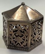An octagonally shaped pierced silver wax jack with hinged cover.