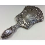 A fine and heavy Gorham silver mirror heavily chased with flowers.