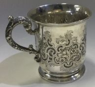 A Victorian silver christening mug with chased decoration. London 1846.