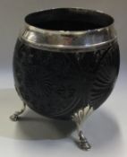 An 18th Century George III silver coconut cup on feet.
