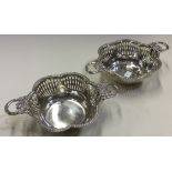 A pair of silver dishes with swag handles and pierced decoration. Birmingham 1909.