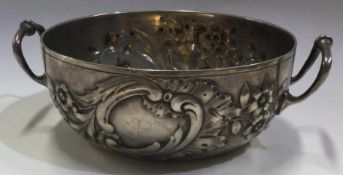 A rare chased Continental silver two-handled bowl embossed with flowers.
