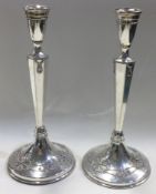 A rare pair of Victorian silver candlesticks realistically modelled with flowers.