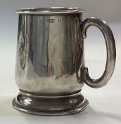 An Art Deco silver christening mug.