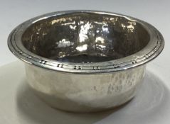 LIBERTY & CO: A silver bowl with hammered border.