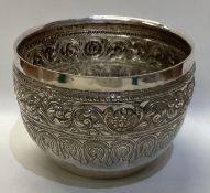 A large and heavy Indian silver bowl with scroll decoration.