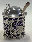 A rare and fine pierced silver mustard pot decorated with birds and flowers.