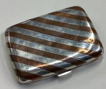 A silver and brown enamelled cigarette case.