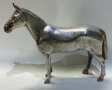 A good cast silver figure of a racehorse with textured body.