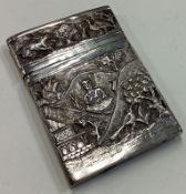 A heavy chased Indian silver card case with hinged lid.