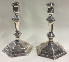 A fine and heavy pair of George I cast silver six-sided candlesticks.