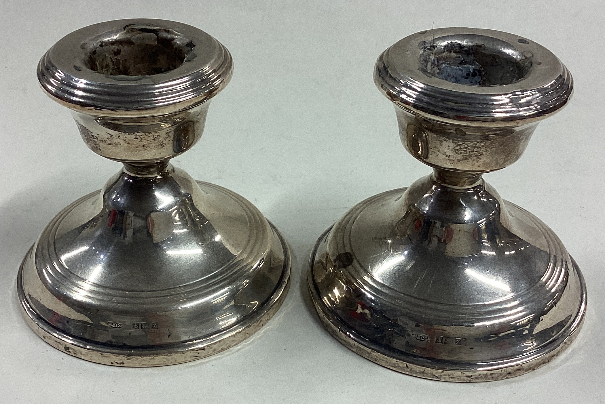 A pair of silver piano candlesticks.