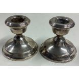 A pair of silver piano candlesticks.