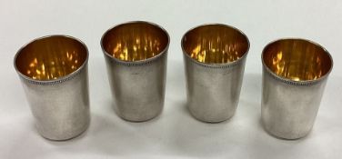 A set of four Russian silver stacking shot cups.