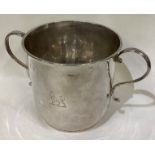 An early Queen Anne silver porringer with central armorial.