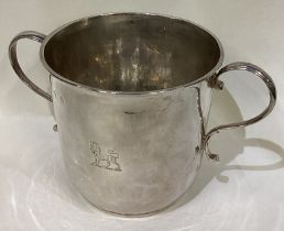 An early Queen Anne silver porringer with central armorial.