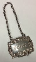 A Victorian silver wine label for 'Port' with grapevine decoration.