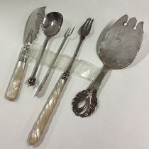 A stylish silver slice together with a pickle fork etc.