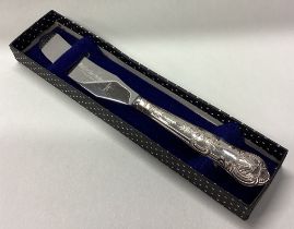 A cased silver handled butter knife.
