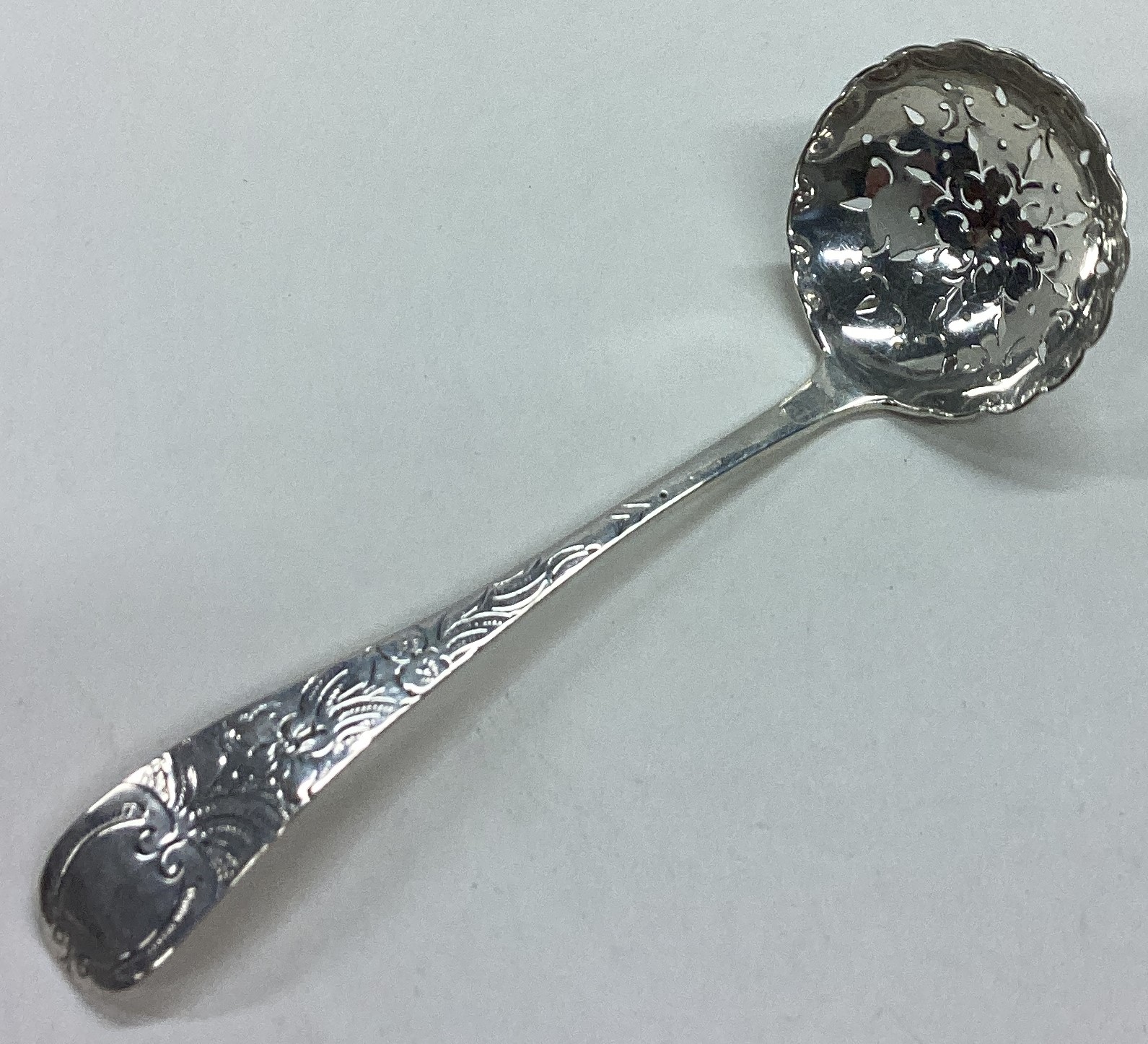 A Victorian silver ladle with pierced decoration.