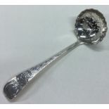 A Victorian silver ladle with pierced decoration.