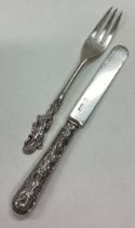 A Chinese silver knife and fork christening set.