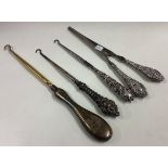 A mixed lot of silver button hooks and glove stretchers.