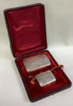 A cased Russian silver cigarette case and snuff box.