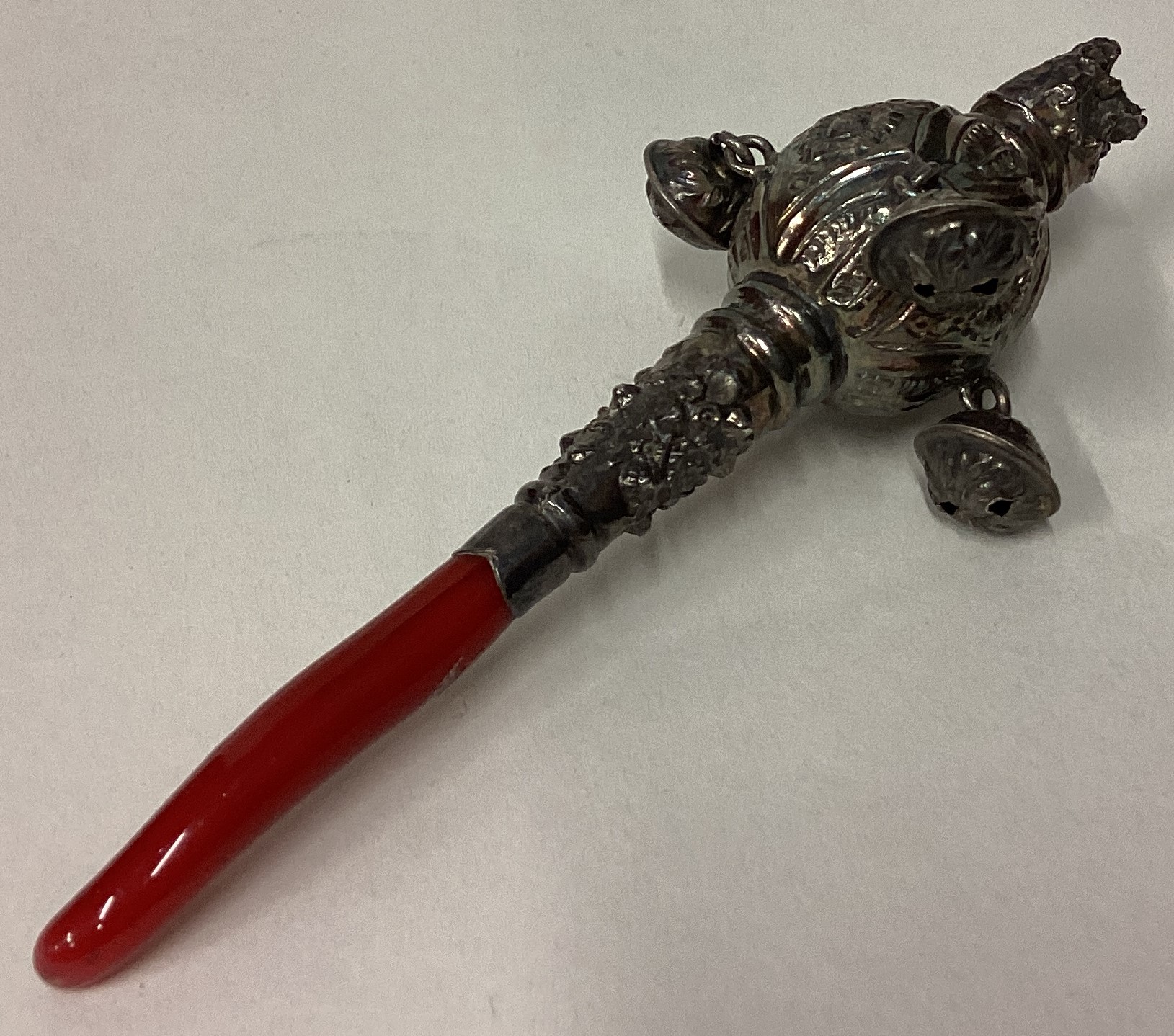 A 19th Century silver rattle with coral teether.