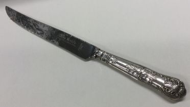 A large silver handled bread knife.